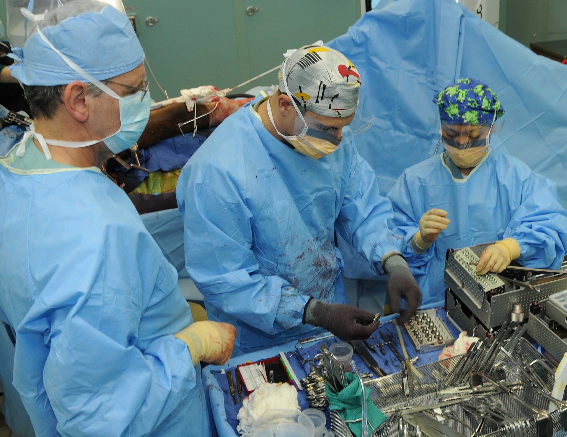 Orthopaedic surgical team performing an open reduction internal fixation procedure