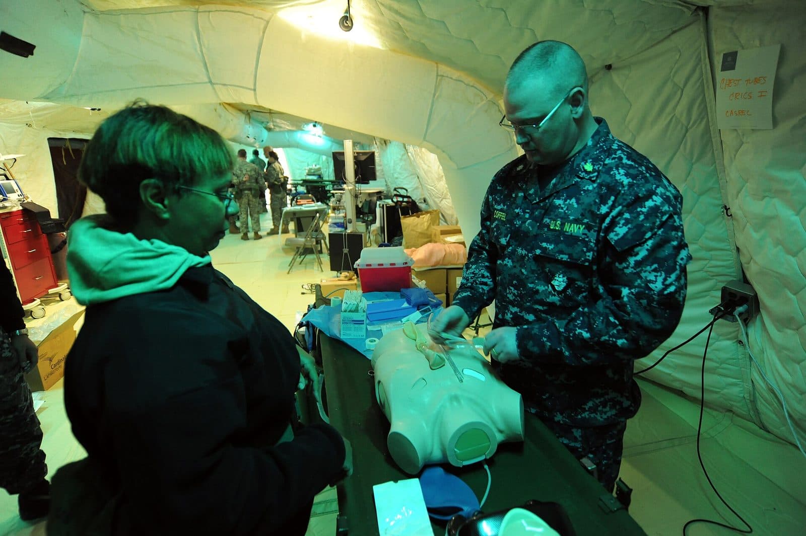 Senior surgeon teaching a junior clinician at the bedside