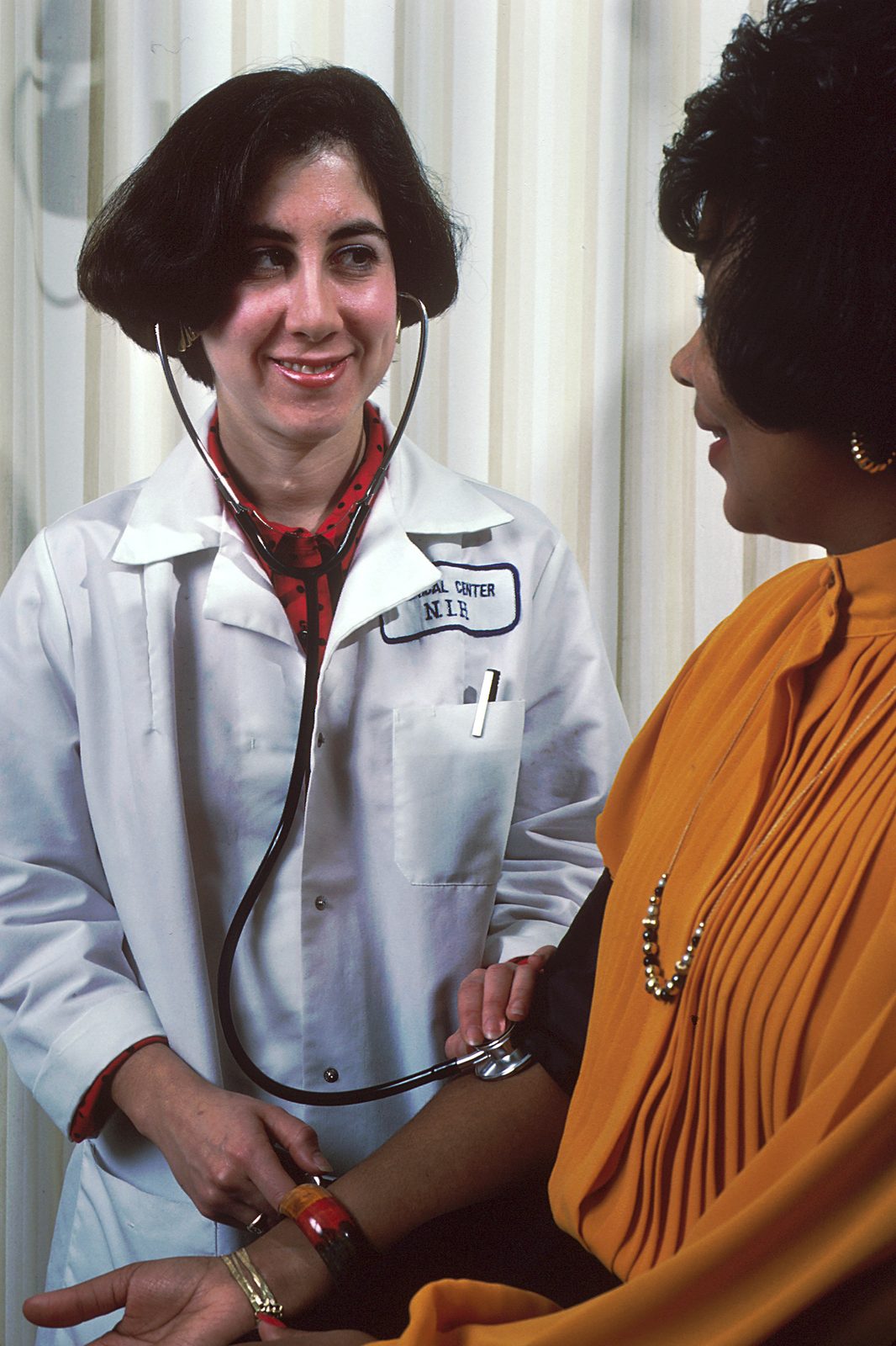 A nurse takes a patient's blood pressure during a clinic visit.