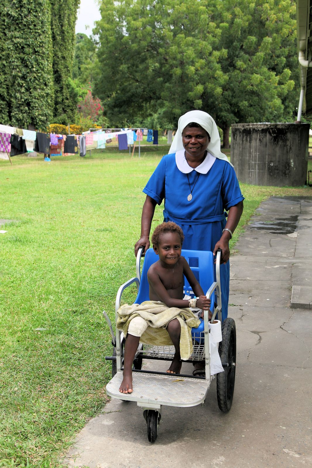 Nurse caring for a patient at a community hospital in Papua New Guinea.
