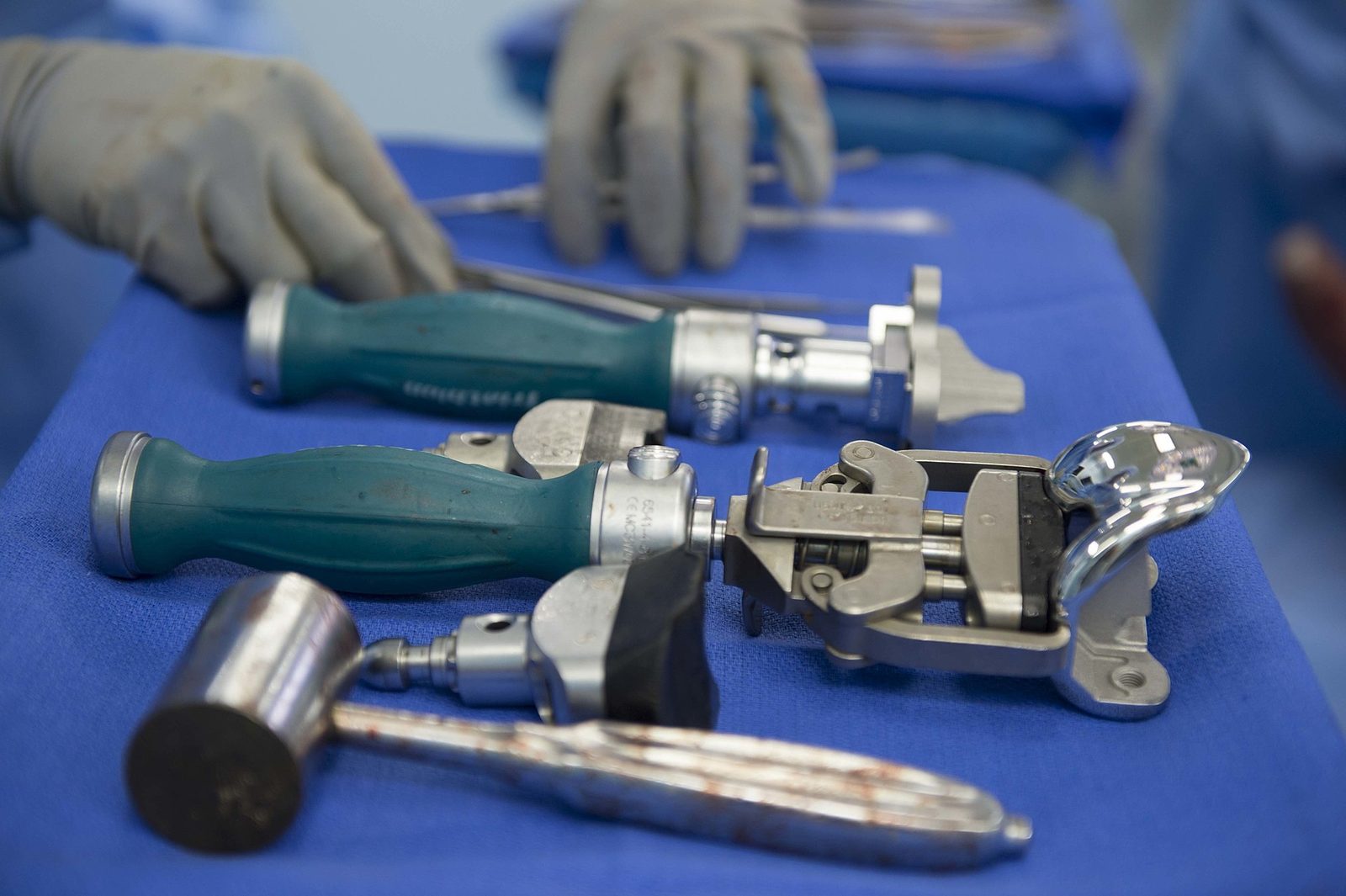Surgical team performing a total joint replacement during an international partnership mission.