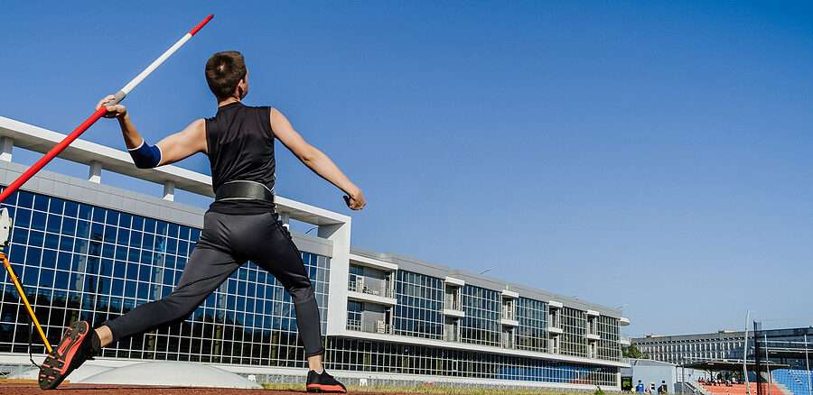 male athlete javelin throw at track and field competition